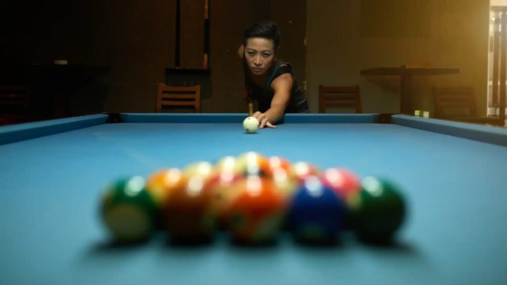 Focused woman aiming pool shot at billiard table with racked balls.